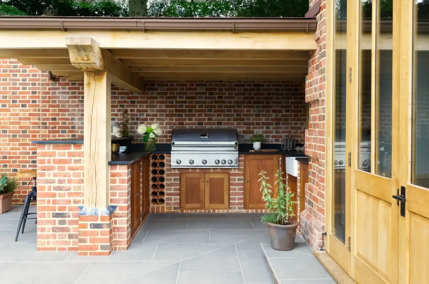 Traditional brickwork gives the outdoor kitchen its character. A sheltered place to cook, gather and enjoy the garden.