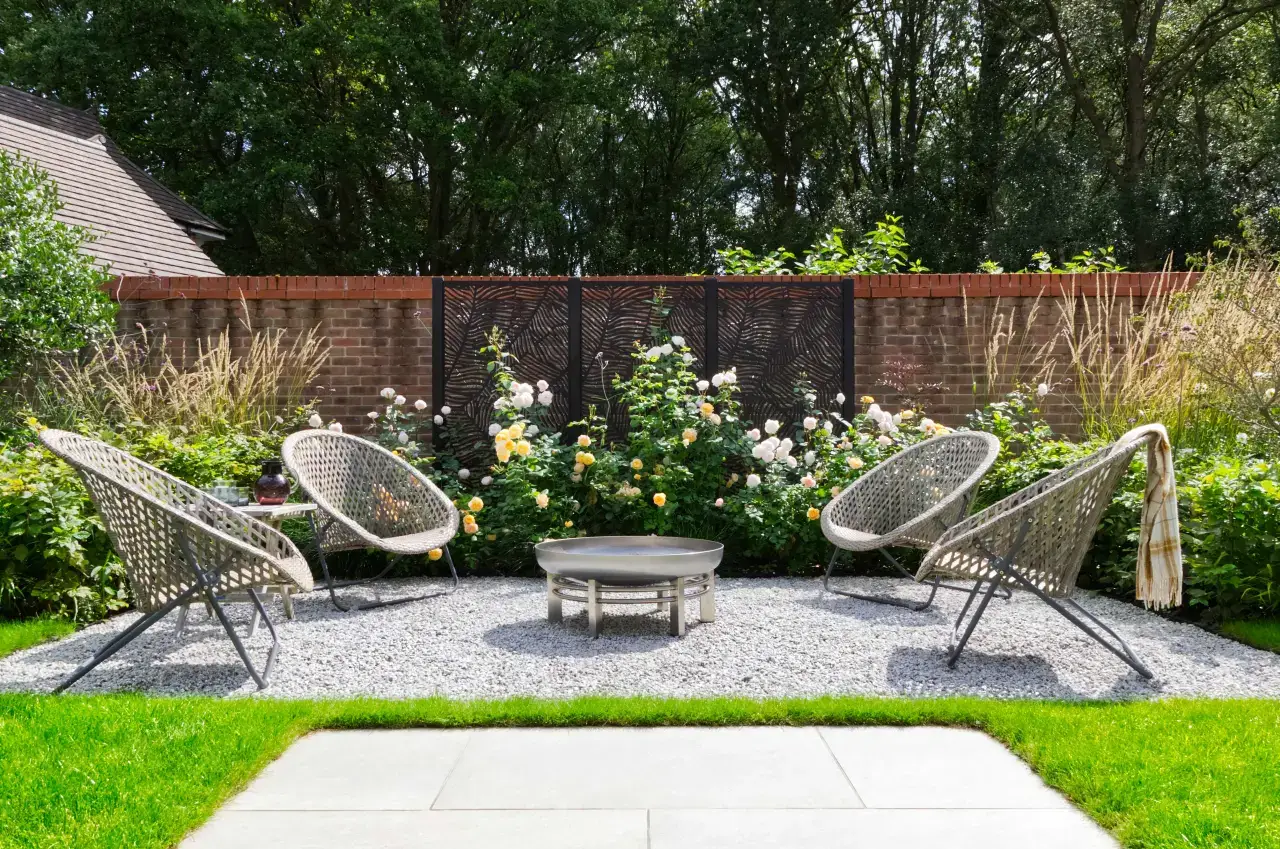 A secluded seating area surrounded by planting in the Urban Garden